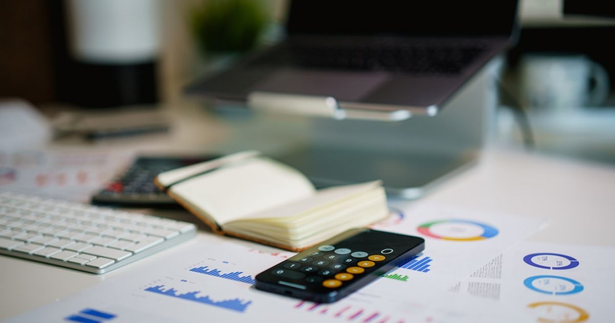 Calculating earnings with a calculator and paperwork